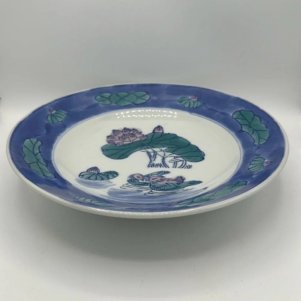 Chinese blue, white, and teal serving bowl with birds and lily pads